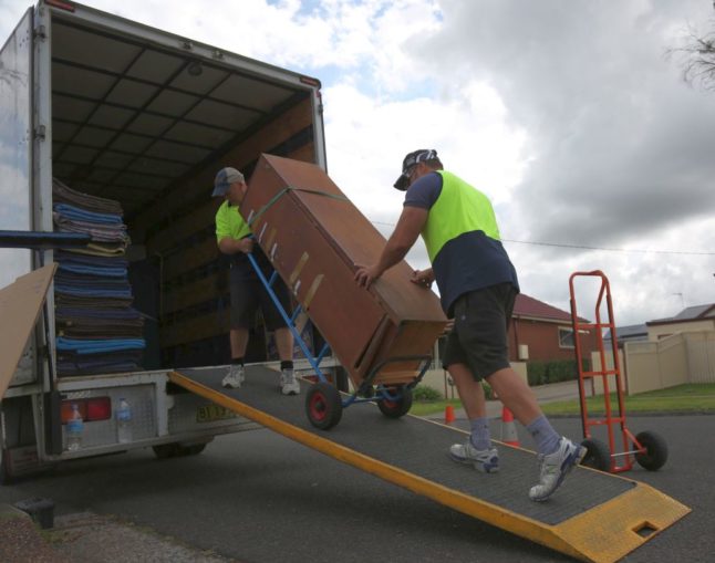 Removals men loading a van